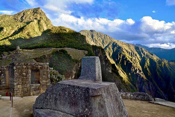  Intihuatana stone and the back the Machu Picchu Mountains and Huayna Picchu 